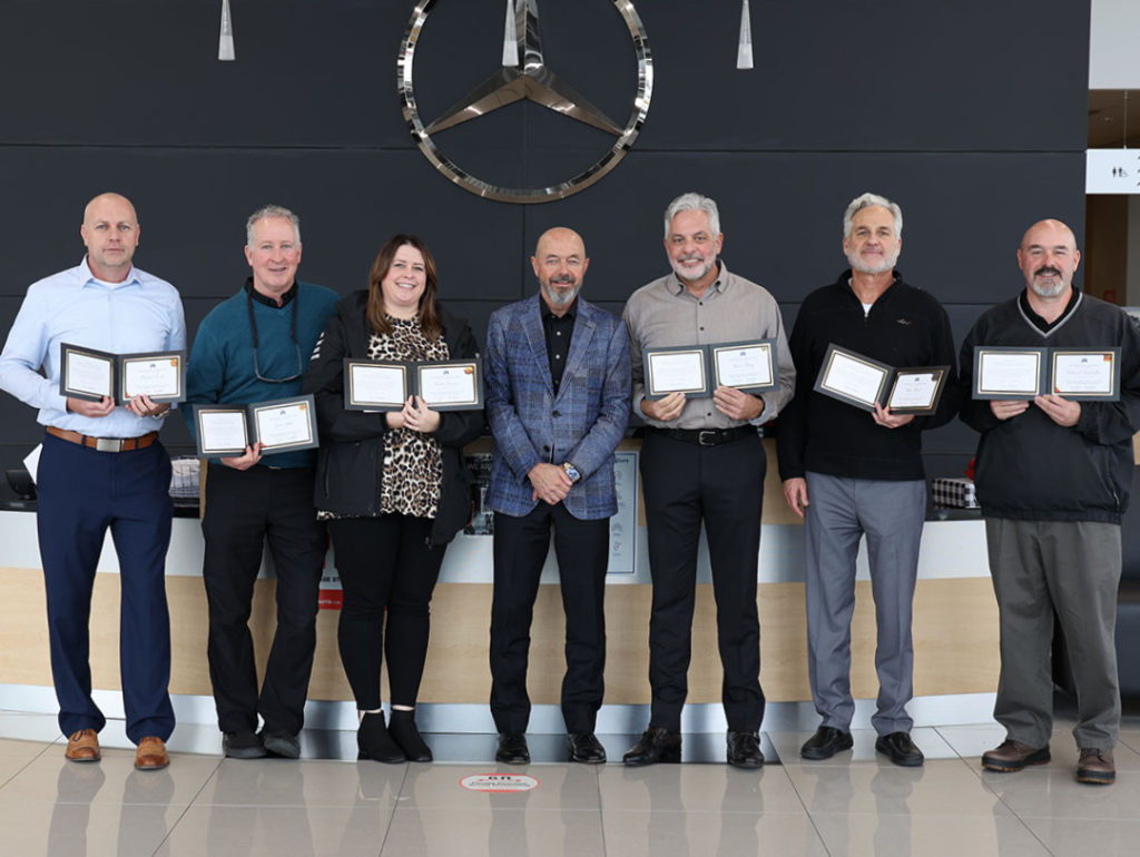 Dealership employees with certificates